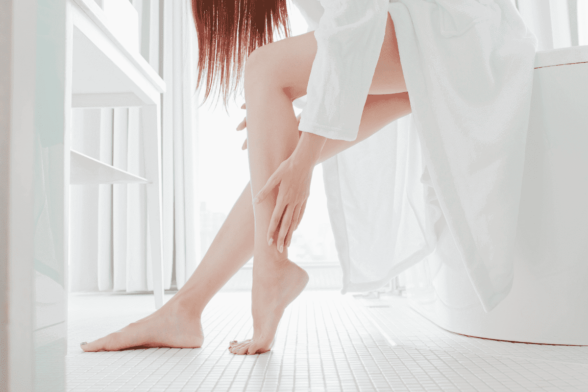 woman applying lotion to dry skin