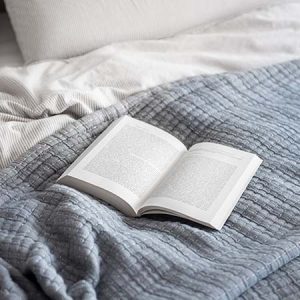 bed with pillows and a book