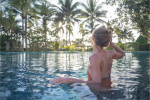 Best Wellness Retreats in the World Header Image featuring a woman in a pool.