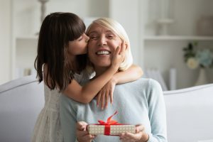 Woman Getting a Book Gift from Granddaughter