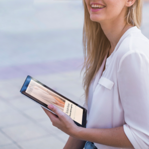woman holding tablet outside Cover