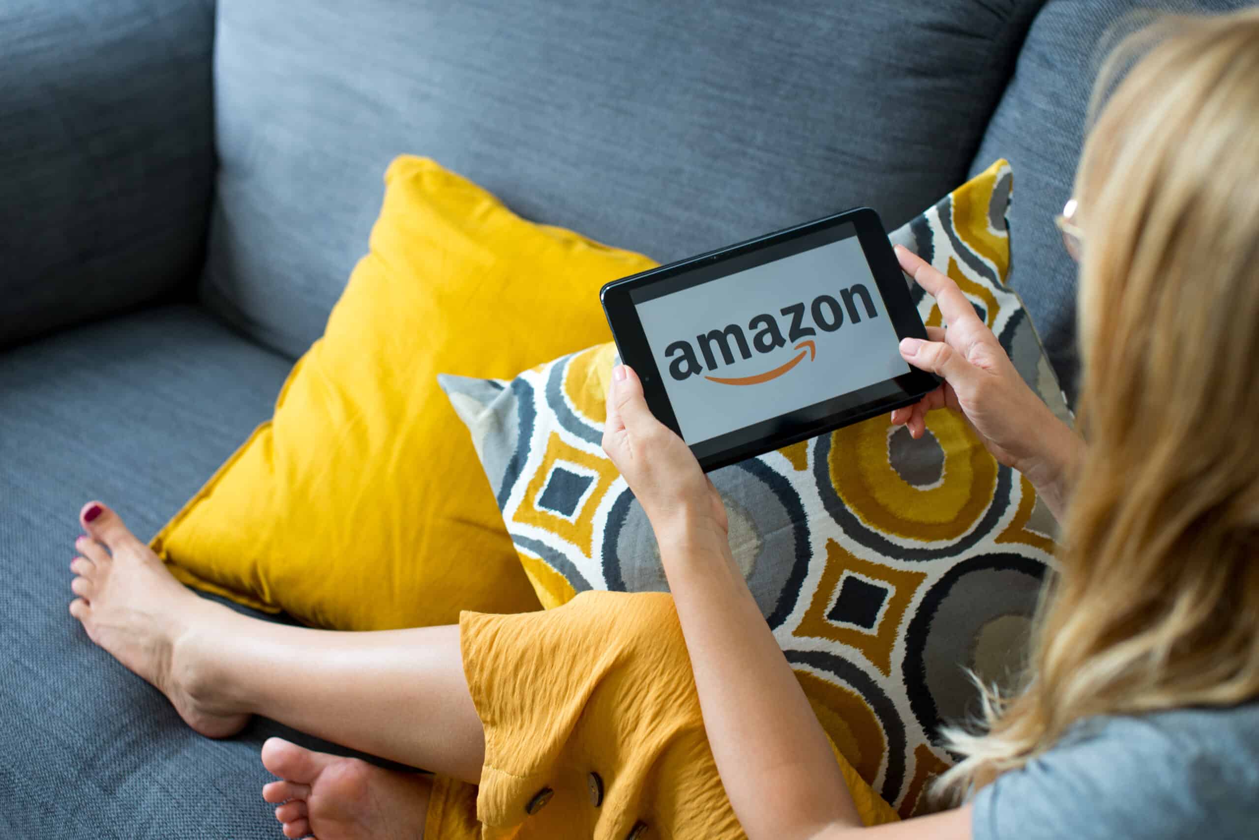Woman looking up Amazon Prime perks on a tablet.