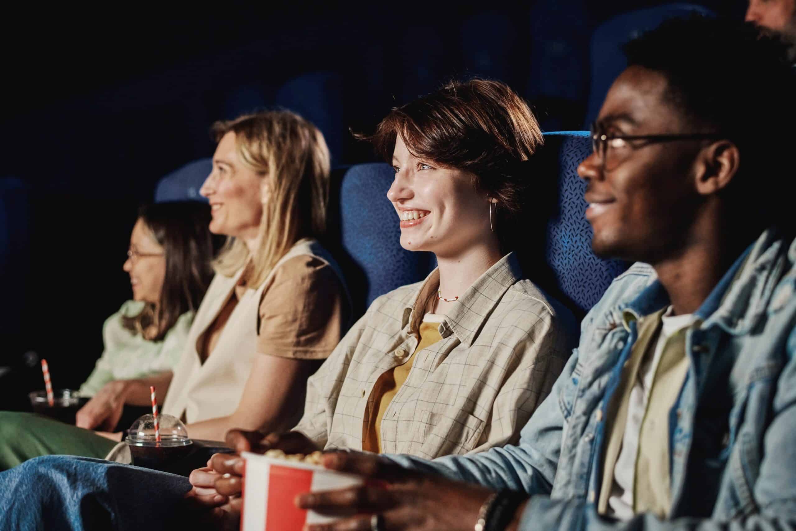 A group of friends watching fall 2022 new releases in the movie theater.