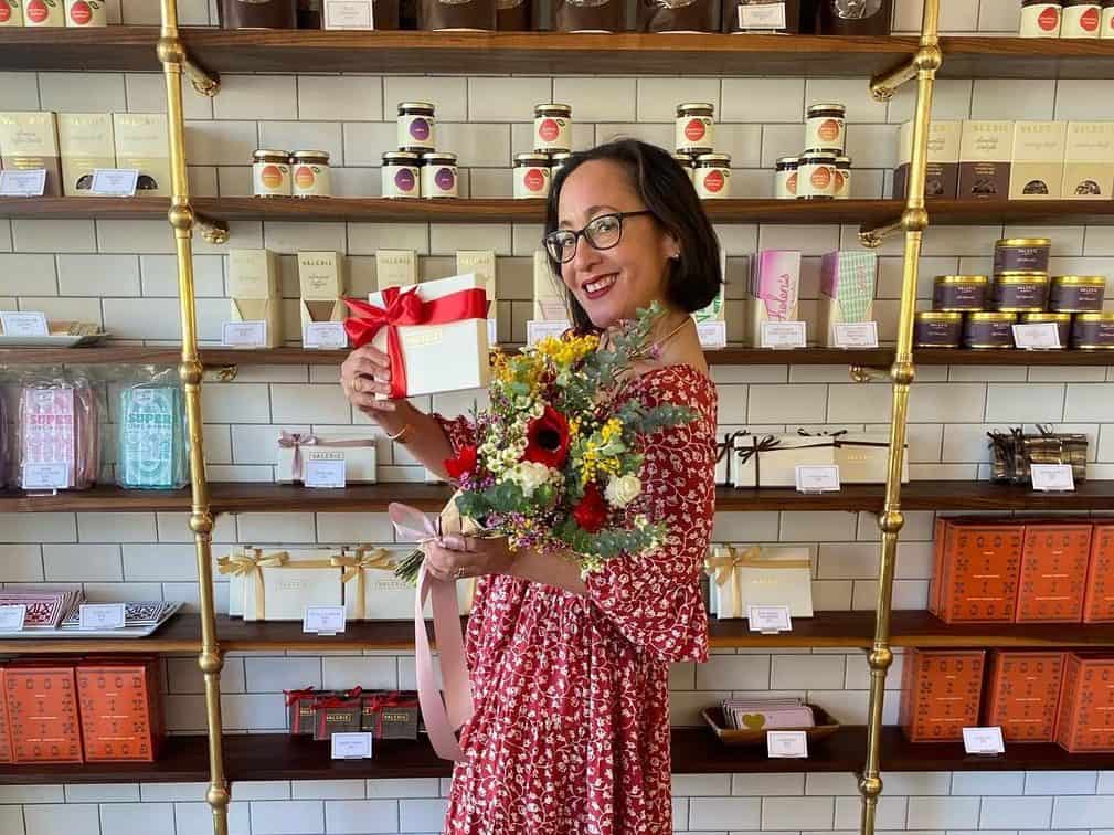 Valerie Gordon, owner of Valerie Confections, stands it front of its shelves. 