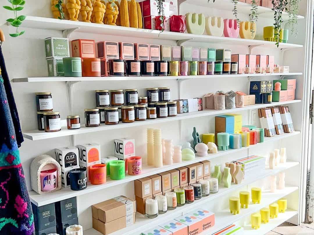 Shelves at Prelude and Dawn, a small business in Highland Park, are filled with colorful candles and decor objects. 