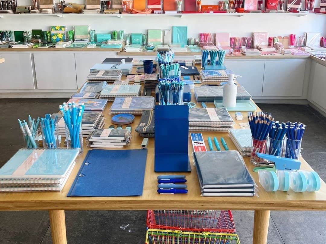 A rainbow of stationery products are spread across the tables and shelves of Shorthand. 