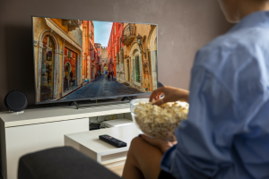 Woman watches tv in Sicily, Taormina is the main location for White Lotus.