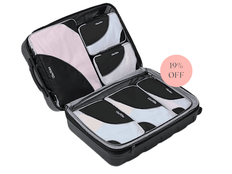 An open suitcase with neatly packaged packing cubes full of clothing. 