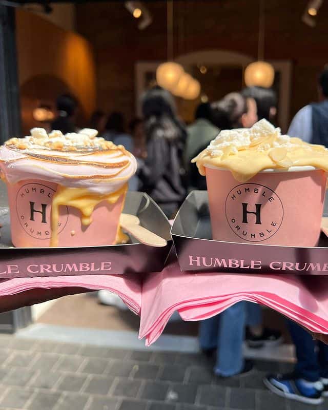 Two dessert crumbles in light pink packaging from Humble Crumble. 