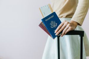 Woman holding a passport in her hand.