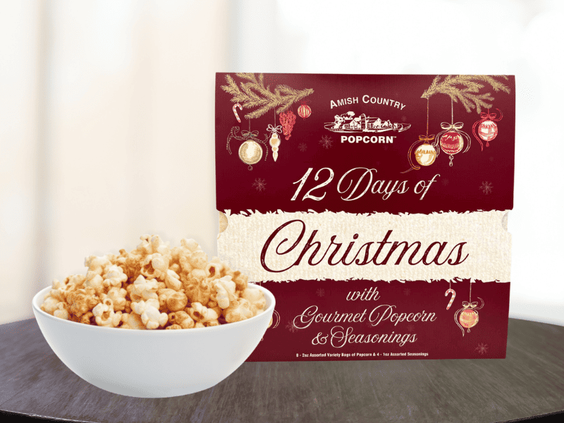 A 12-day advent calendar beside a bowl of popcorn. 