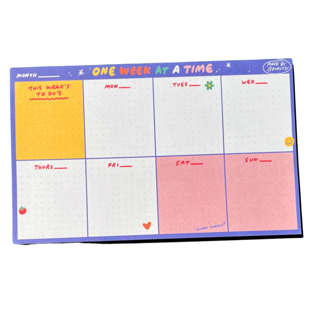 A colorful weekly desk planner features hand-written labels and a colored weekend feature. 