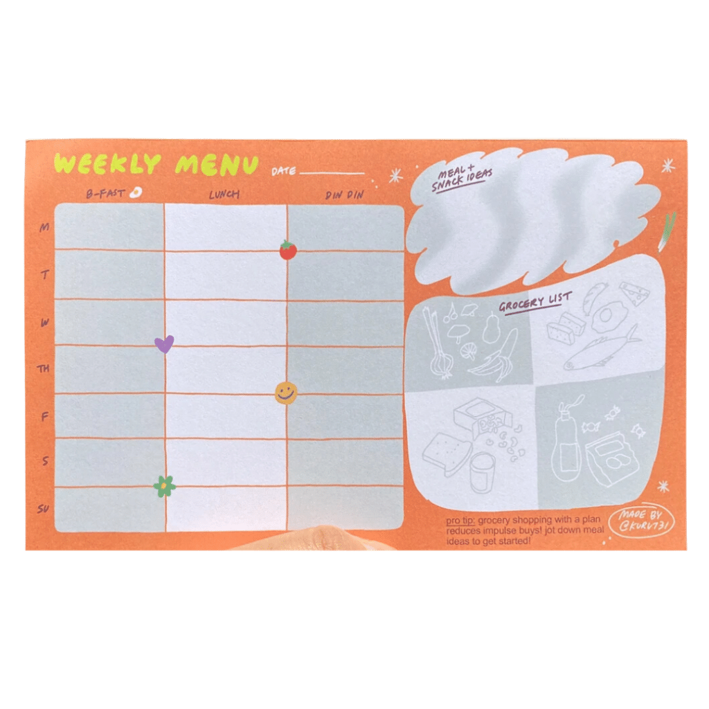 A orange colored weekly planner has space for planning meals, shopping, and brainstorming. 